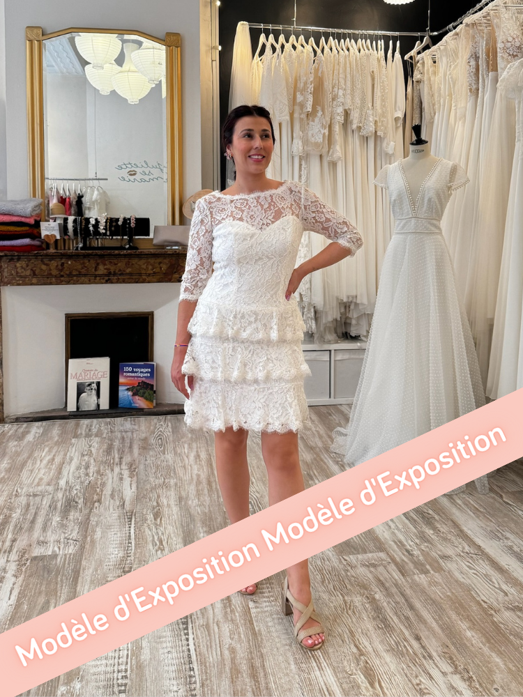 Robe de mariée courte intégralement confectionnée en dentelle.